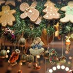 Christmas-themed paper wall hanging craft featuring gingerbread cookie shapes, handmade ornaments, and natural decorations