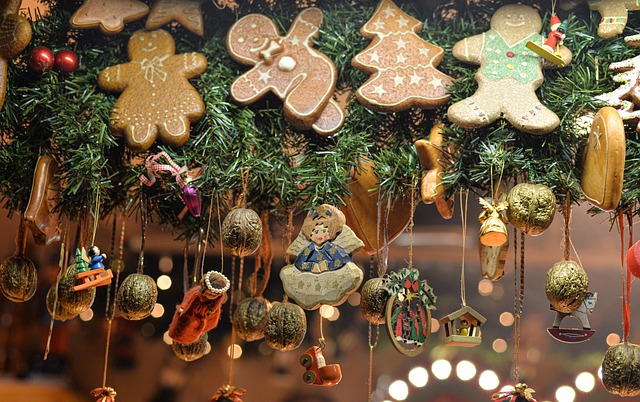 Christmas-themed paper wall hanging craft featuring gingerbread cookie shapes, handmade ornaments, and natural decorations