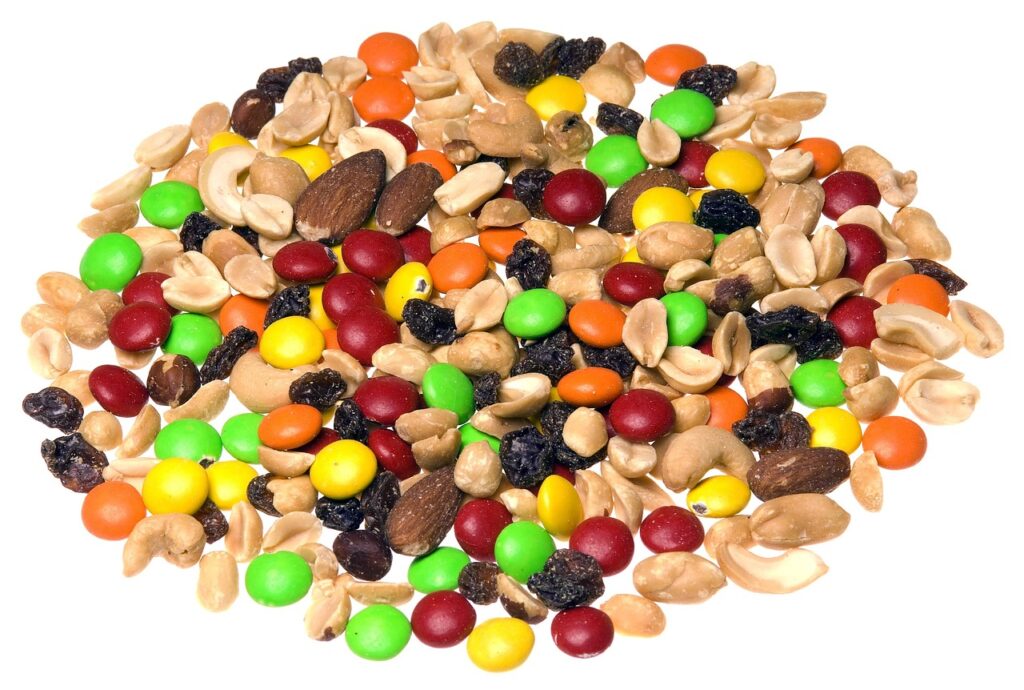 A colorful mix of peanuts, raisins, almonds, cashews, and candy-coated chocolates served as healthy snacks for kids.