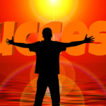 Silhouette of a person embracing success at sunrise, symbolizing the daily routine of a successful person