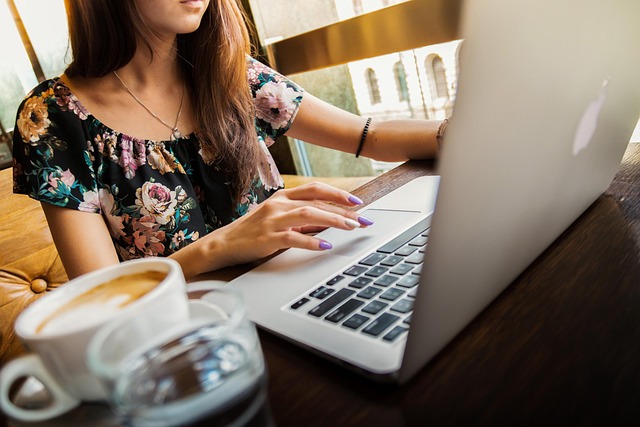 Woman working on a laptop at a cafe while researching how to get a remote job with no experience