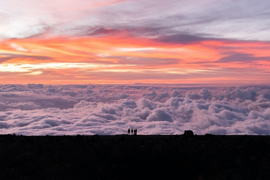 Breathtaking sunset above the clouds at Haleakalā National Park in Maui, Hawaii – one of the most beautiful places in the world