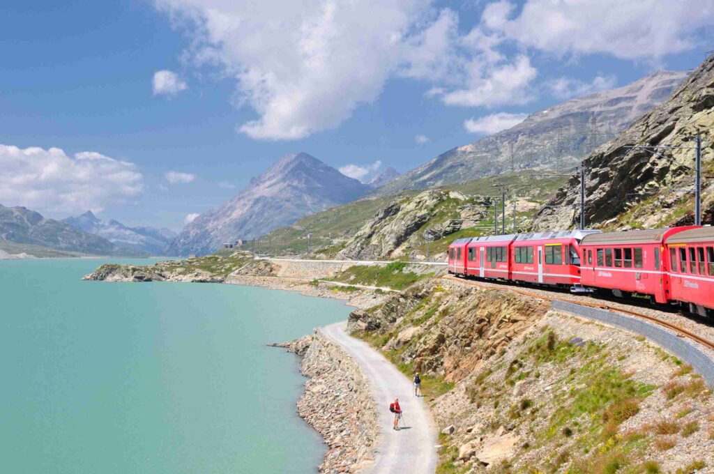 The Bernina Express between Switzerland and Italy, one of the most scenic train rides in the world, crossing alpine landscapes, glaciers, and spiral viaducts.