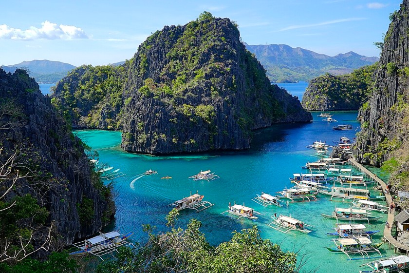 Palawan, Philippines with dramatic limestone cliffs, crystal-clear lagoons, and white sandy beaches surrounded by lush greenery.