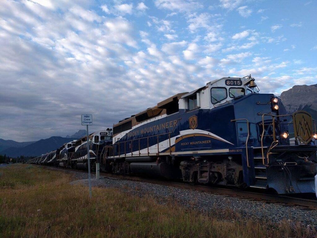The Rocky Mountaineer in Canada, one of the most scenic train rides in the world, passing through the Canadian Rockies with snow-capped mountains, pine forests, and turquoise rivers.
