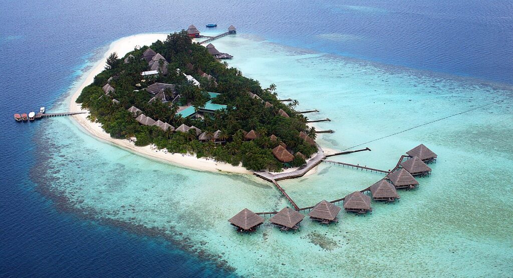 Overwater villas in the Maldives surrounded by turquoise lagoons and coral reefs, showcasing why it is one of the top tropical islands to visit for luxury and romance.