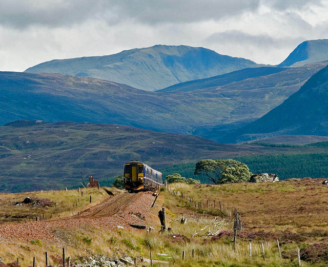 The West Highland Line in Scotland, one of the most scenic train rides in the world, crossing the Glenfinnan Viaduct with sweeping views of the Scottish Highlands, lochs, and rugged landscapes.